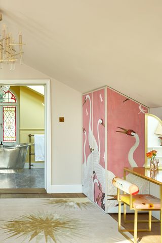 Bedroom with wardrobe wallpapered in pink paper with cranes