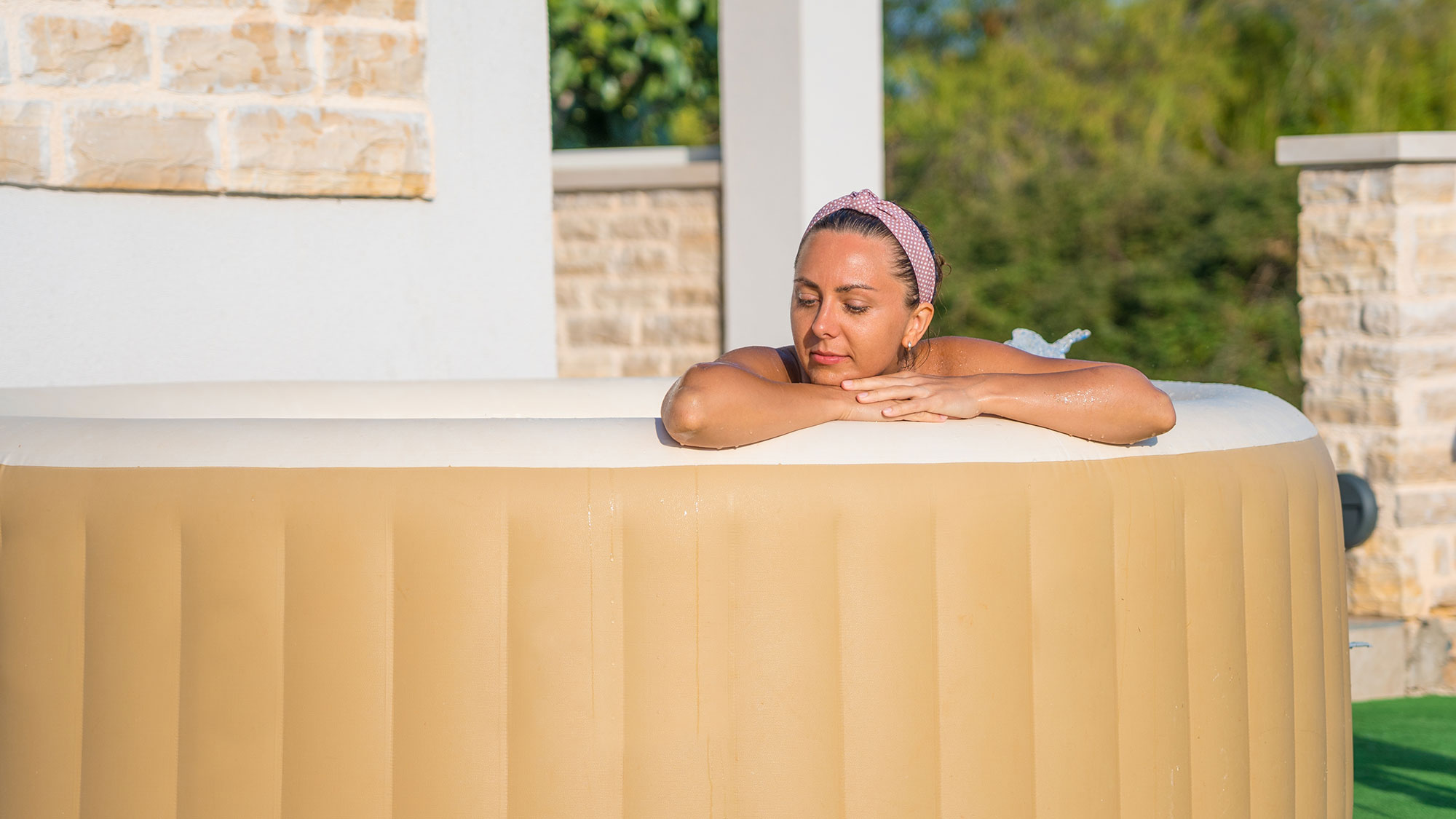 Young woman relaxing in an inflatable jacuzzi