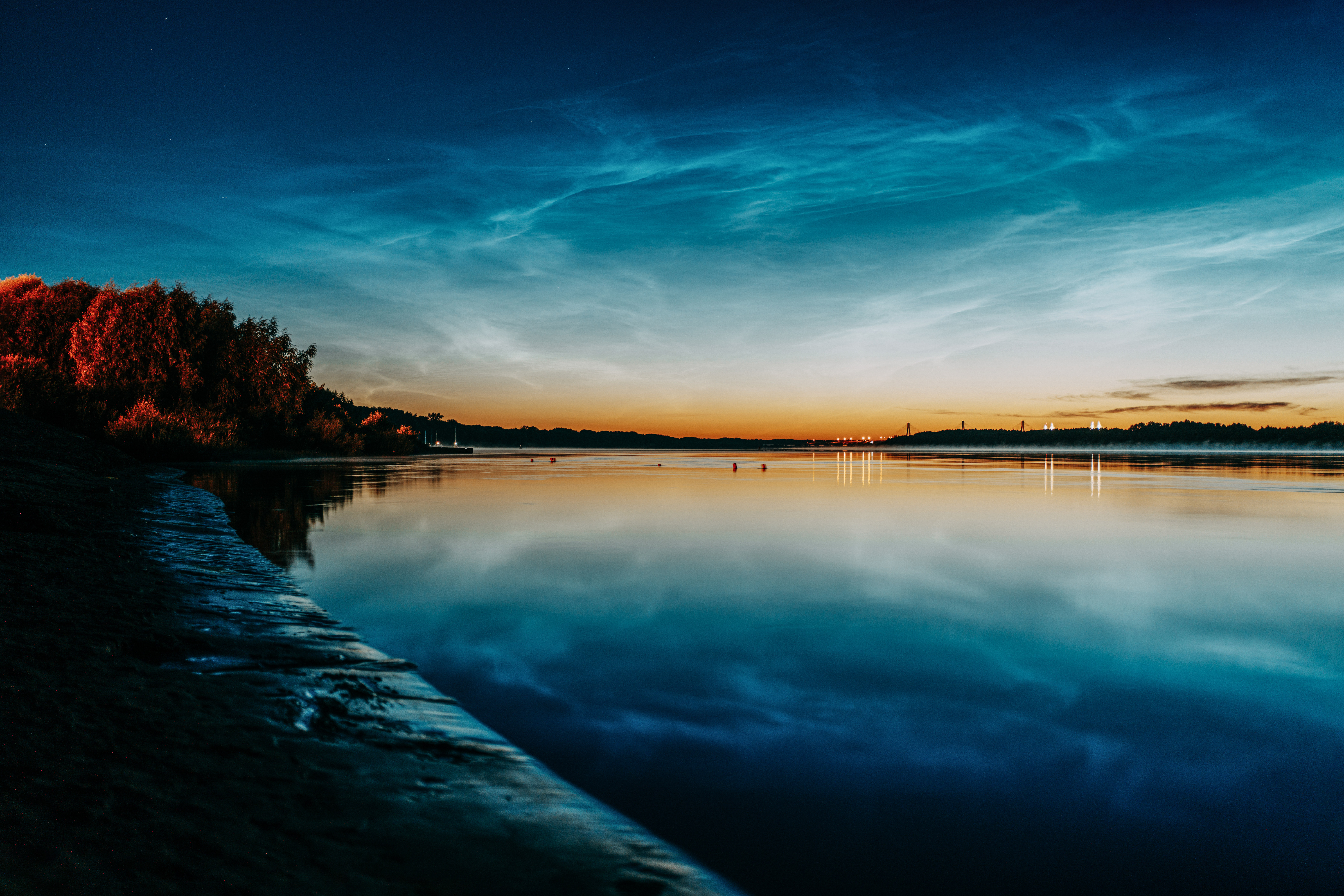 Noctilucent clouds over river