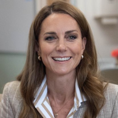 Princess Kate wearing a striped top and blazer smiling