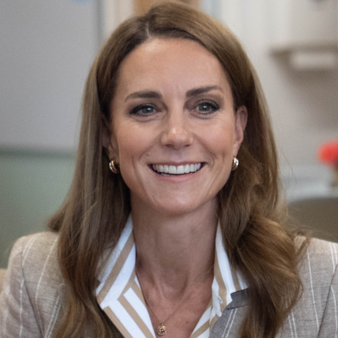 Princess Kate wearing a striped top and blazer smiling