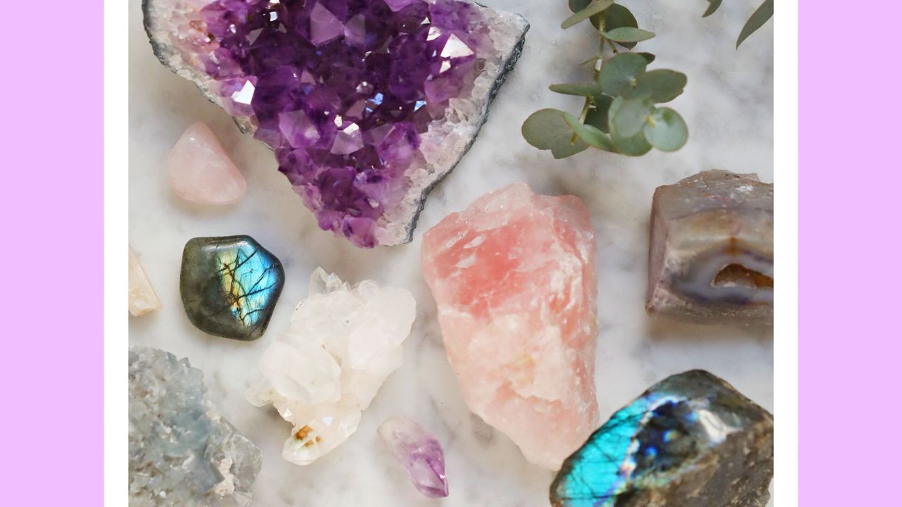 Close-Up Of Gemstones on marble - stock photo. Amethyste, quartz rose, labradorite, citrine, celestine, pierre de lune, rhodonite, quartz,