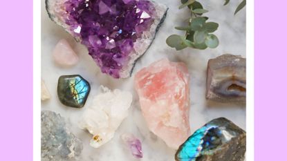 Close-Up Of Gemstones on marble - stock photo. Amethyste, quartz rose, labradorite, citrine, celestine, pierre de lune, rhodonite, quartz,