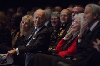 Vice President Joe Biden smiles and looks at Annie Glenn, widow of former astronaut and Senator John Glenn, as Glenn's son David recounts humorous stories about his father.