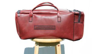 The best Glowforge machines; a photo of a leather duffle bag on a wooden stool
