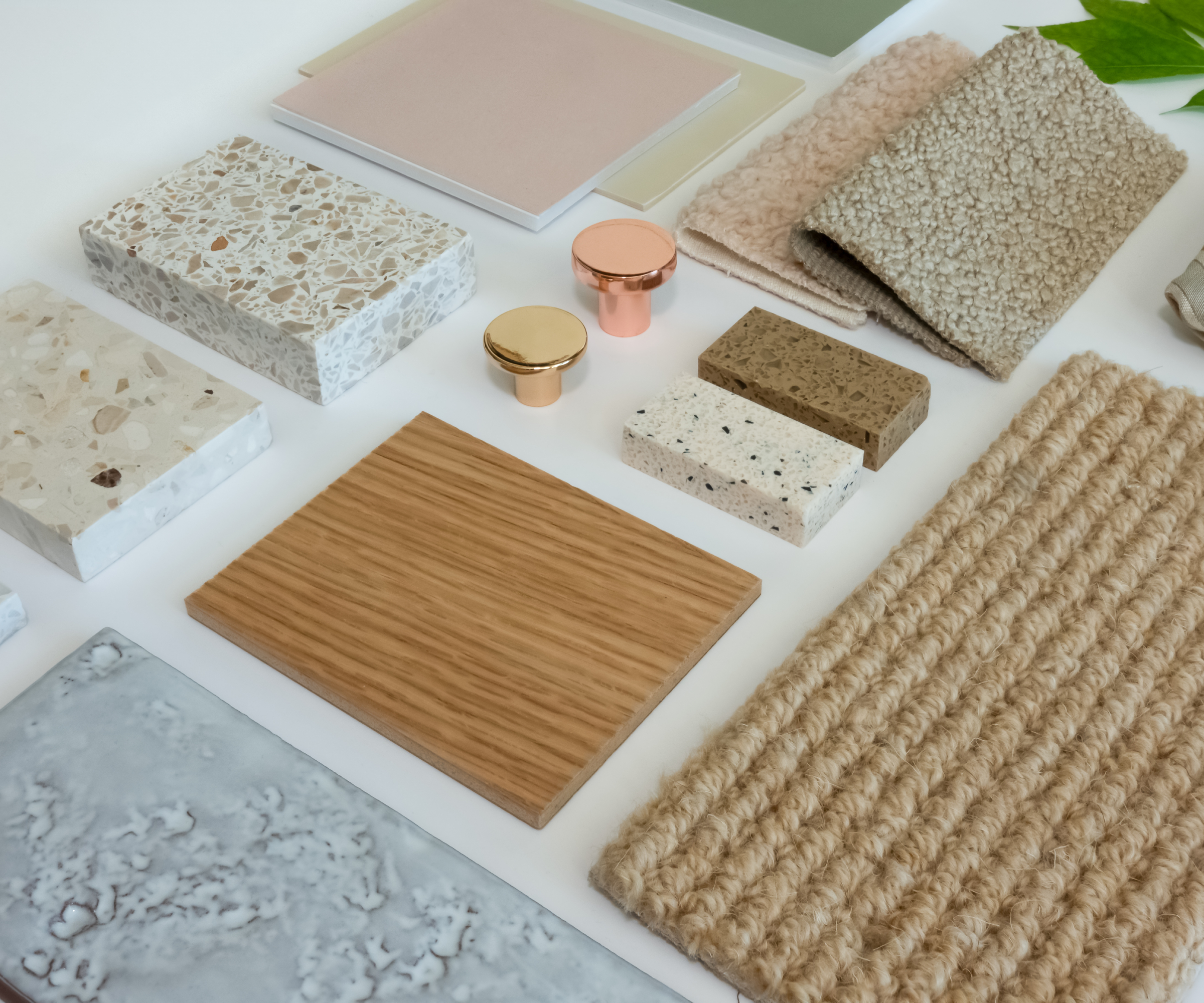 samples of flooring, tiles, worktops and handles on table