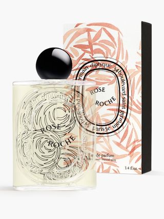 Diptyque Paris Rose Roche - Eau De Parfum beside its box on a white background