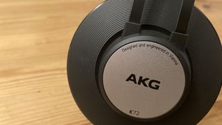 AKG K72 headphones earcup on a wooden surface