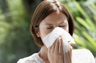 Woman suffering from hay fever symptoms