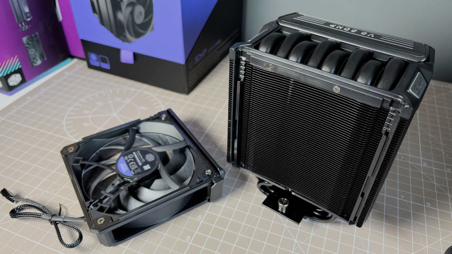 The Cooler Master V8 Ace 3DHP installed on a test bench and on its box.