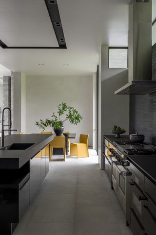 minimalist kitchen with yellow dining chairs