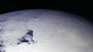 A view of Antarctica from space shows a portion of the globe covered in ice.