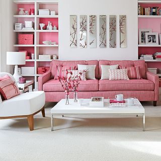 Living room shelving ideas with pink sofa and pink painted alcoves