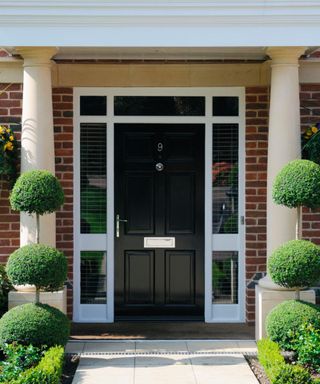 black front door with red brick exterior