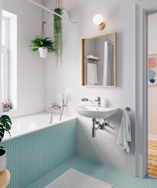 blue and white bathroom with wall hung sink and wooden mirror