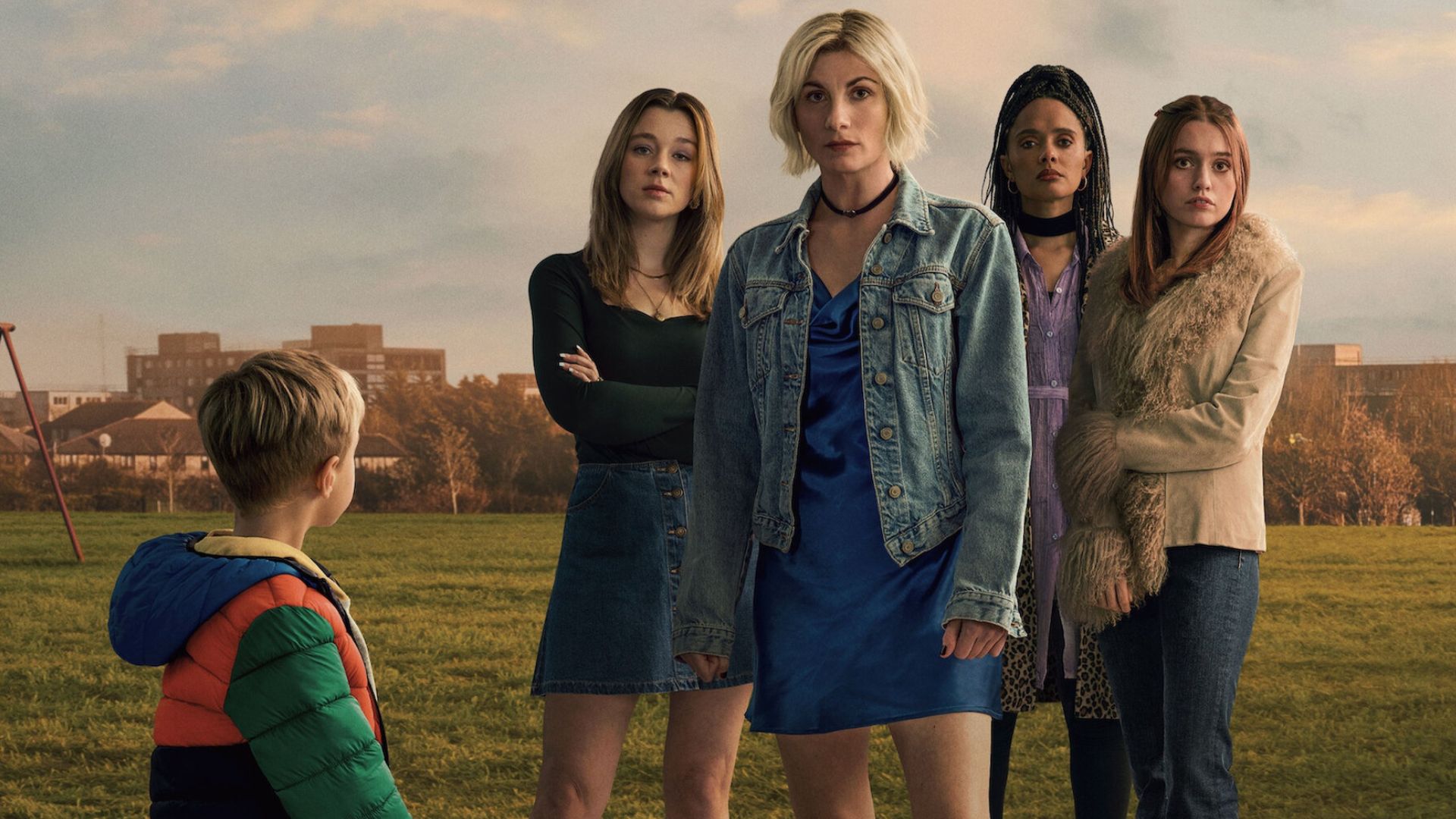 The cast of Toxic Town stand in a field