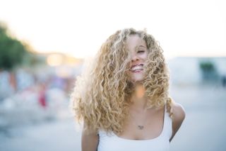woman with blonde loose curly hair