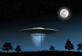 A UFO, or flying saucer, above a dark city and under a full moon.