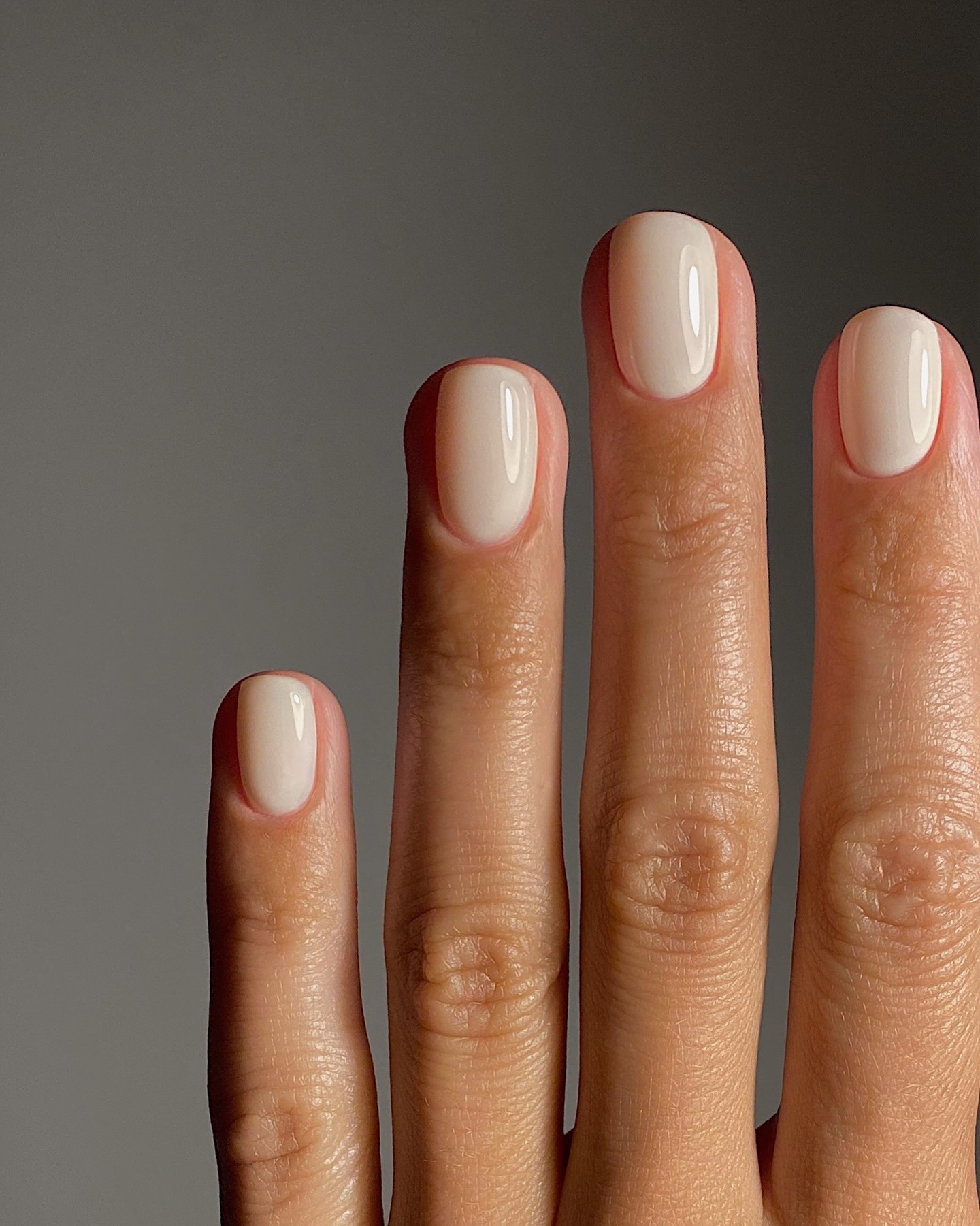 A short, oval-shaped vanilla manicure