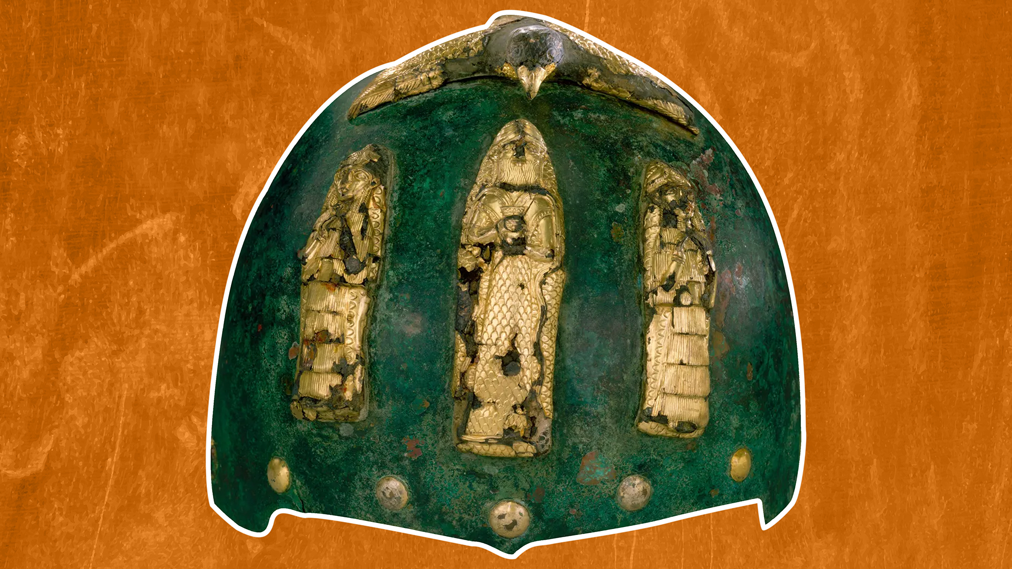a green-tinted bronze helmet with gold figurines on the front