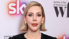 Image of Katherine Ryan smiling with short blonde chin-length bob and wearing gold hoop earrings