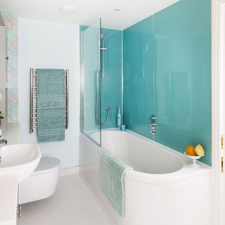 white bathroom with turquoise waterproof wallpaper and white flooring