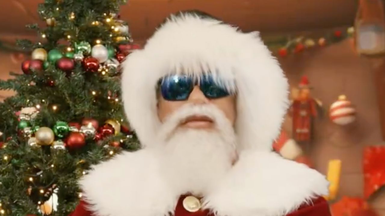 Tiger Woods dressed in a Santa Claus outfit and sunglasses