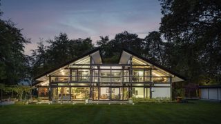A Huf Haus with a glass fronted house and front garden