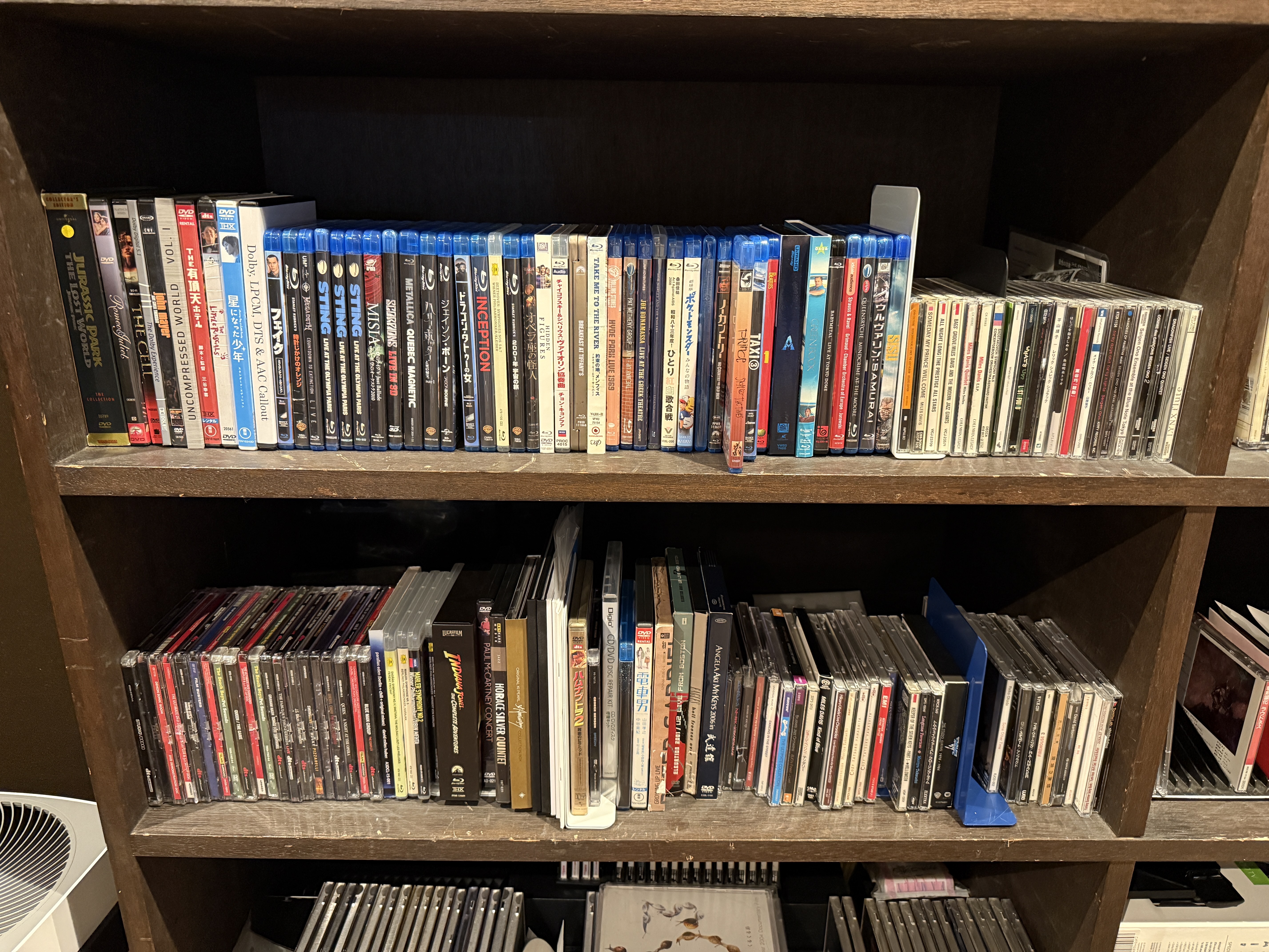 Two shelves full of Blu-ray discs (and some CDs and DVDs)