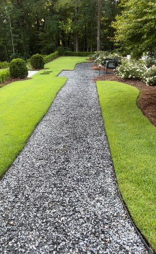 Walkway in chipped slate with lawn either side