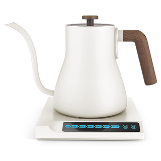 A white and wooden gooseneck kettle on a smart base with touch screen,