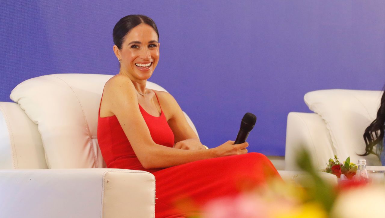 Meghan Markle onstage at the Women in Leadership Nigeria panel wearing a red dress by Orire