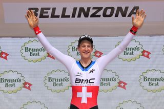 Stefan Kung celebrates on the Tour de Suisse podium after winning the final time trial