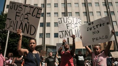 Demonstrators march in Akron, Ohio, following the police shooting of Jayland Walker.