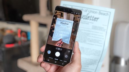 A picture of a person scanning a document using the Galaxy S26's built-in, AI-powered document scanner