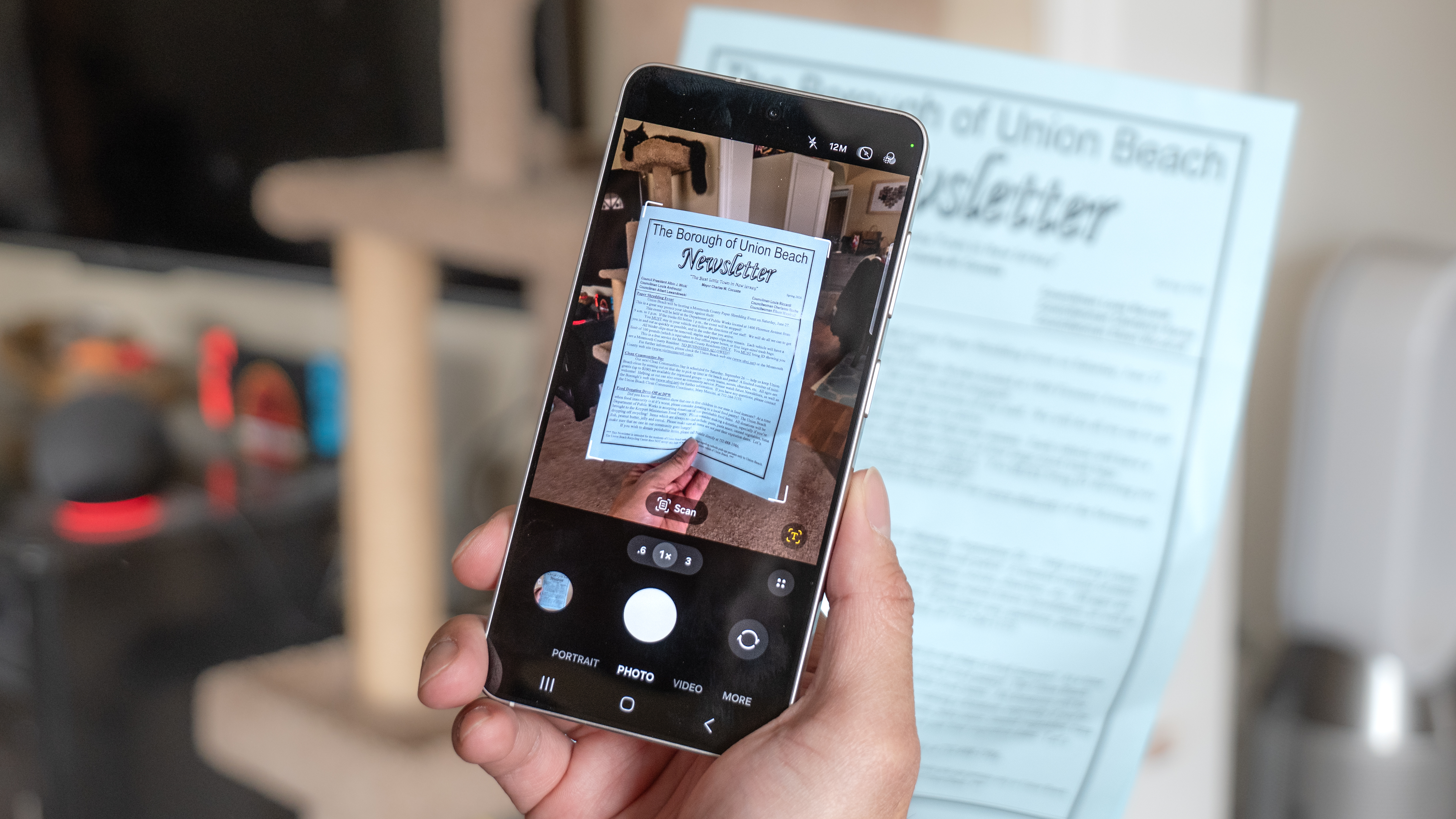 A picture of a person scanning a document using the Galaxy S26's built-in, AI-powered document scanner