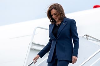 kamala harris deplaning in a navy suit