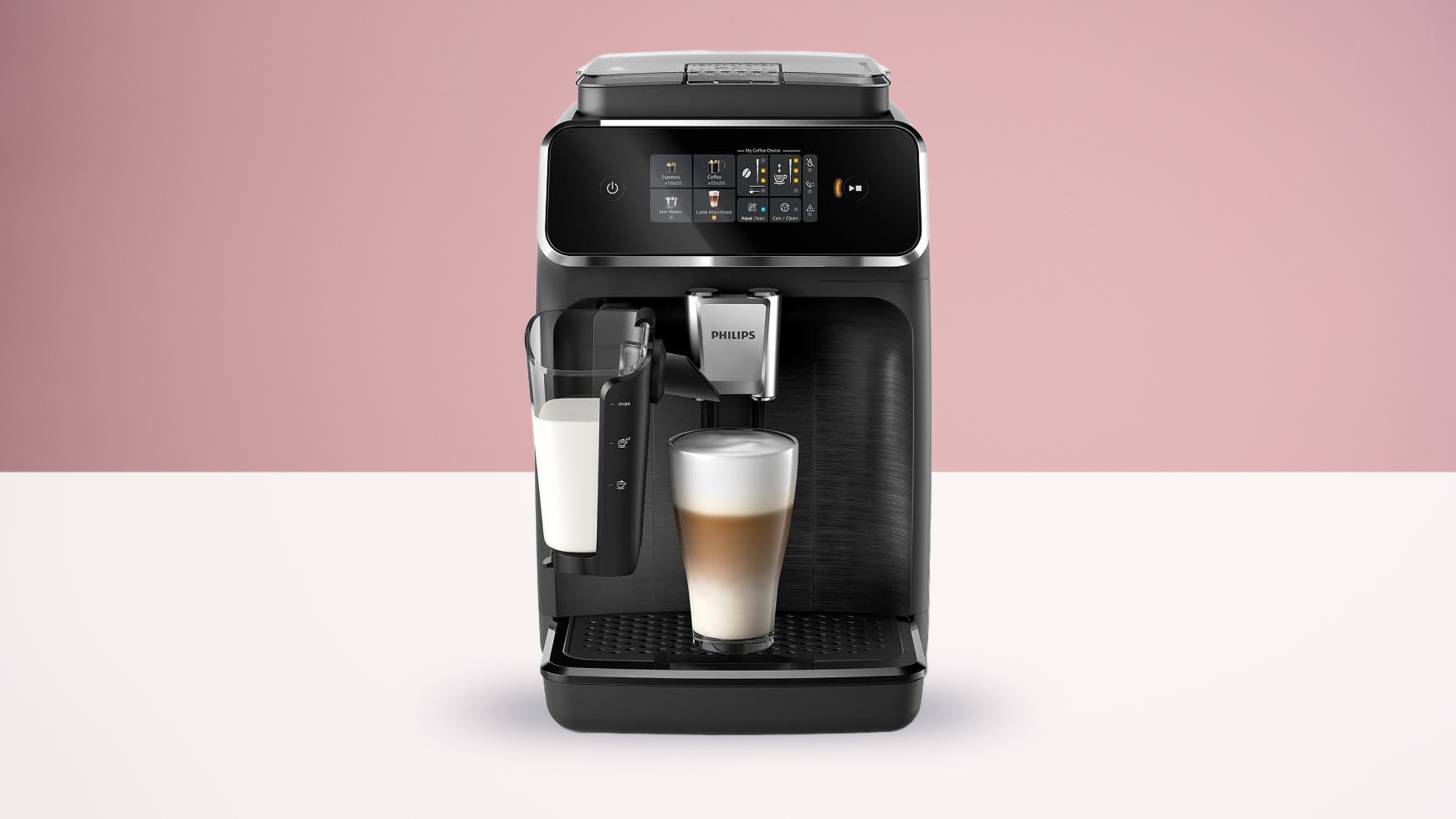 Philips 2300 Series espresso machine on white table against pink wall