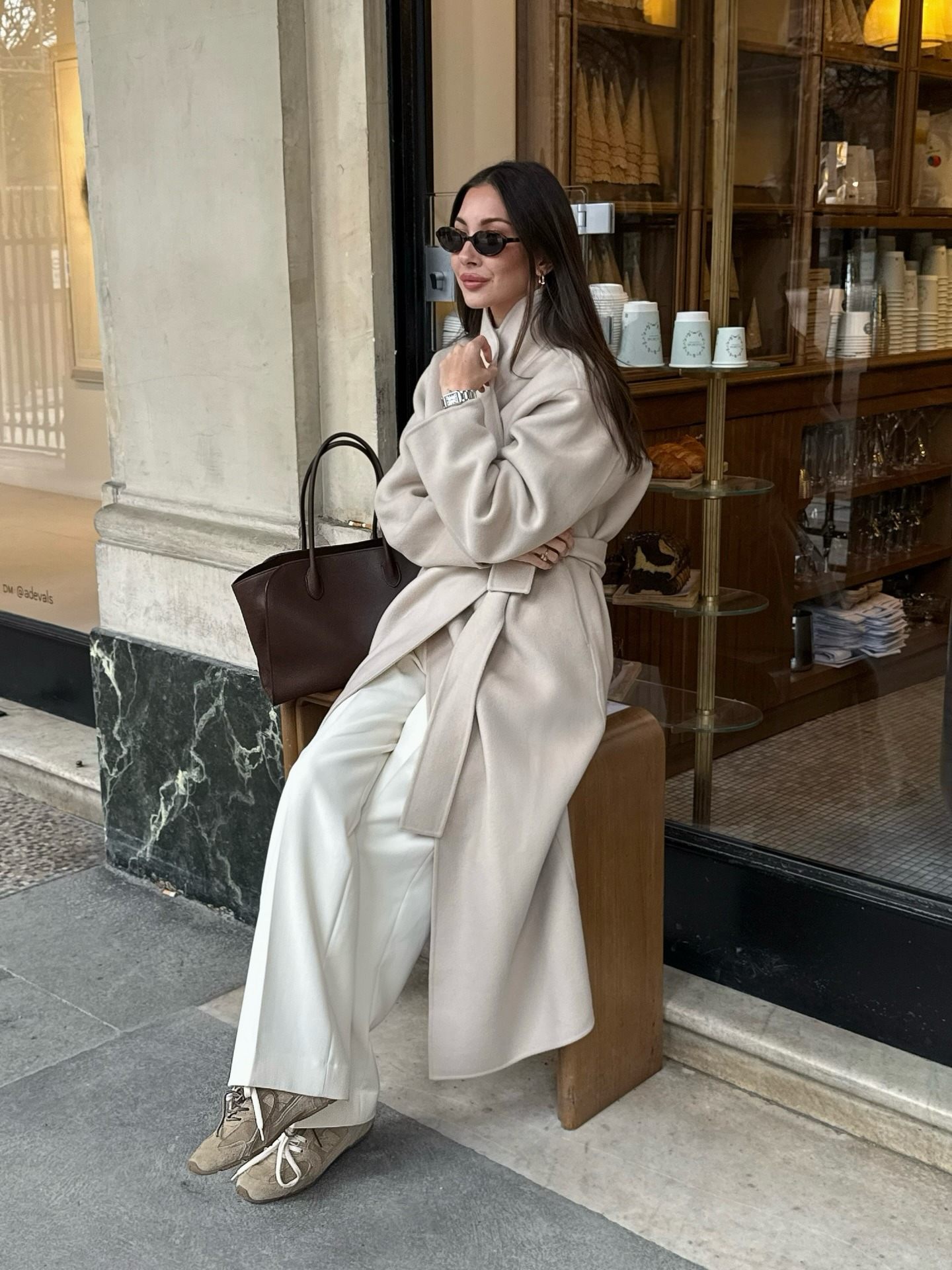 Woman in a chic neutral outfit and suede sneakers