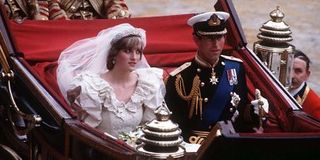 Princess Diana and Prince Charles in a horse drawn carriage on their wedding day.