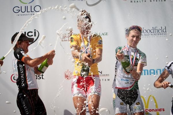 The women getting crazy with the champagne on the podium.