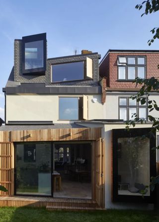 modern extension and loft conversion with oriel windows and sliding doors