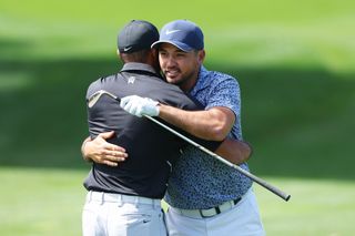 Jason Day hugs Tiger Woods on the practice range during The Masters