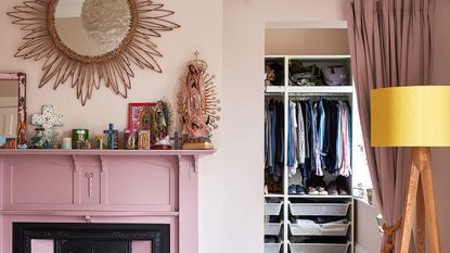 Pink bedroom with fireplace and organized walk in closet