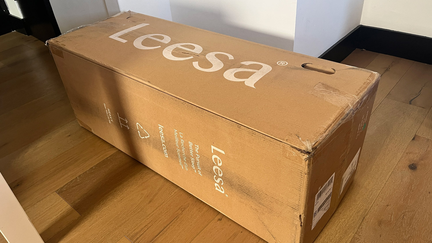 The Leesa Sapira Hybrid Mattress in its delivery box