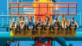 A car of riders in the middle of a freefall in Zumanjaro Drop of Doom.