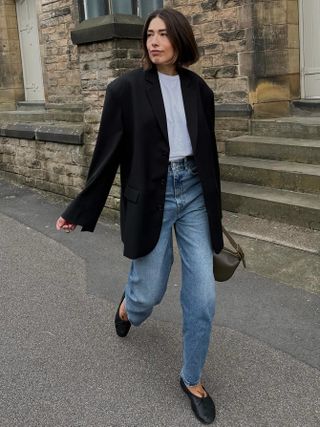 Fashion influencer Lucy Alston wearing a chic fall outfit with jeans.