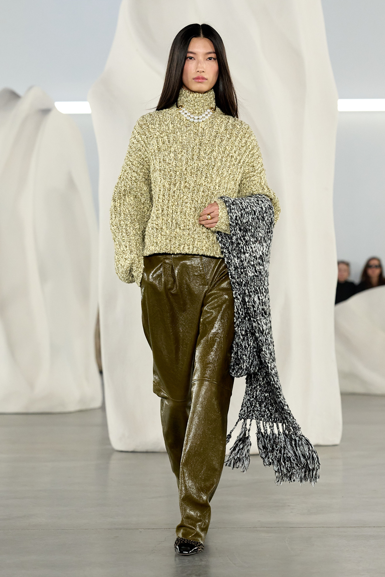 Ulla Johnson Fall 2026 runway, model wearing a green turtleneck and leather pants