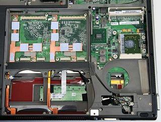 Interior with 7800 GTX processors and CPU cooling system removed. The CPU is the large green square with the gray vertical rectangle in the middle. Gray color is thermal grease.