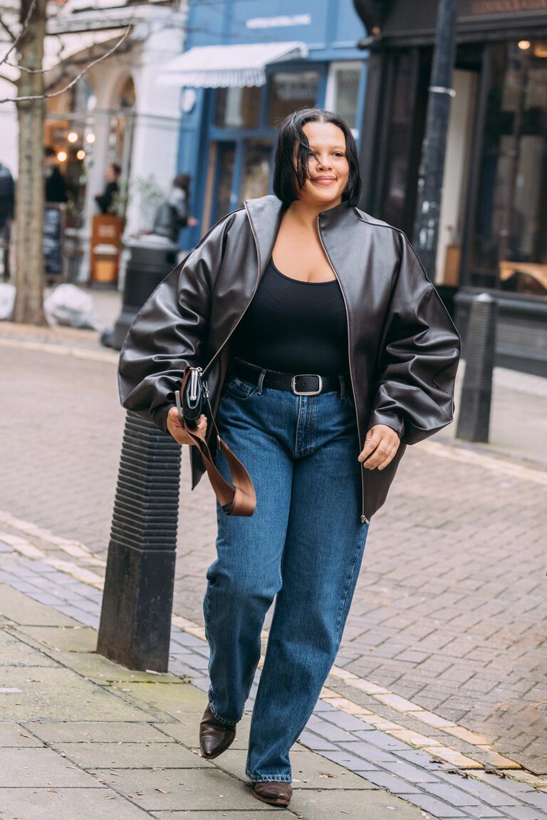 A guest attending shows during London Fashion Week wearing jeans with ankle boots.